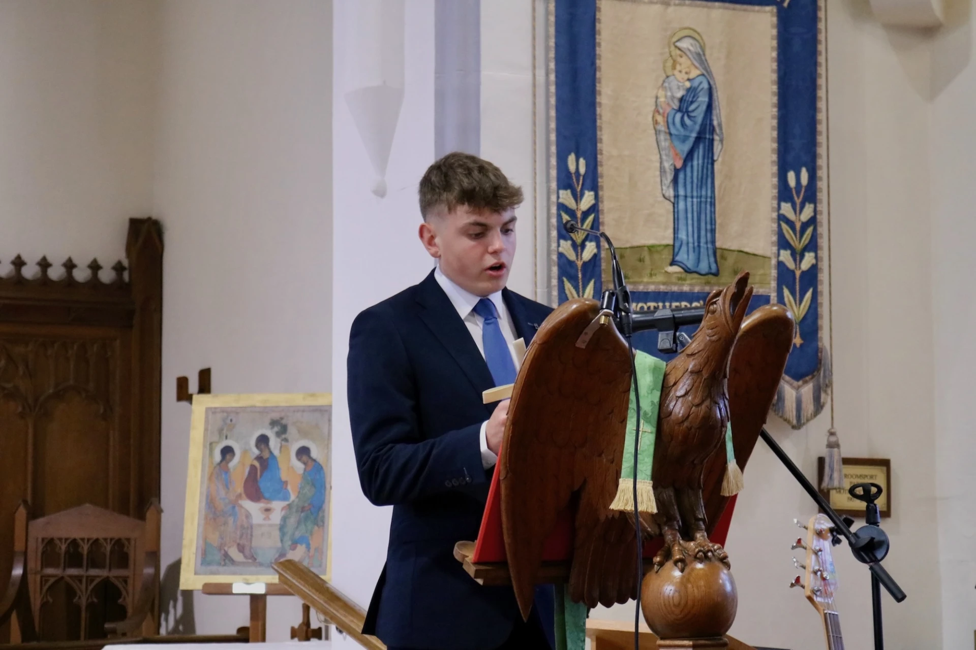 A young parishioner gives the reading