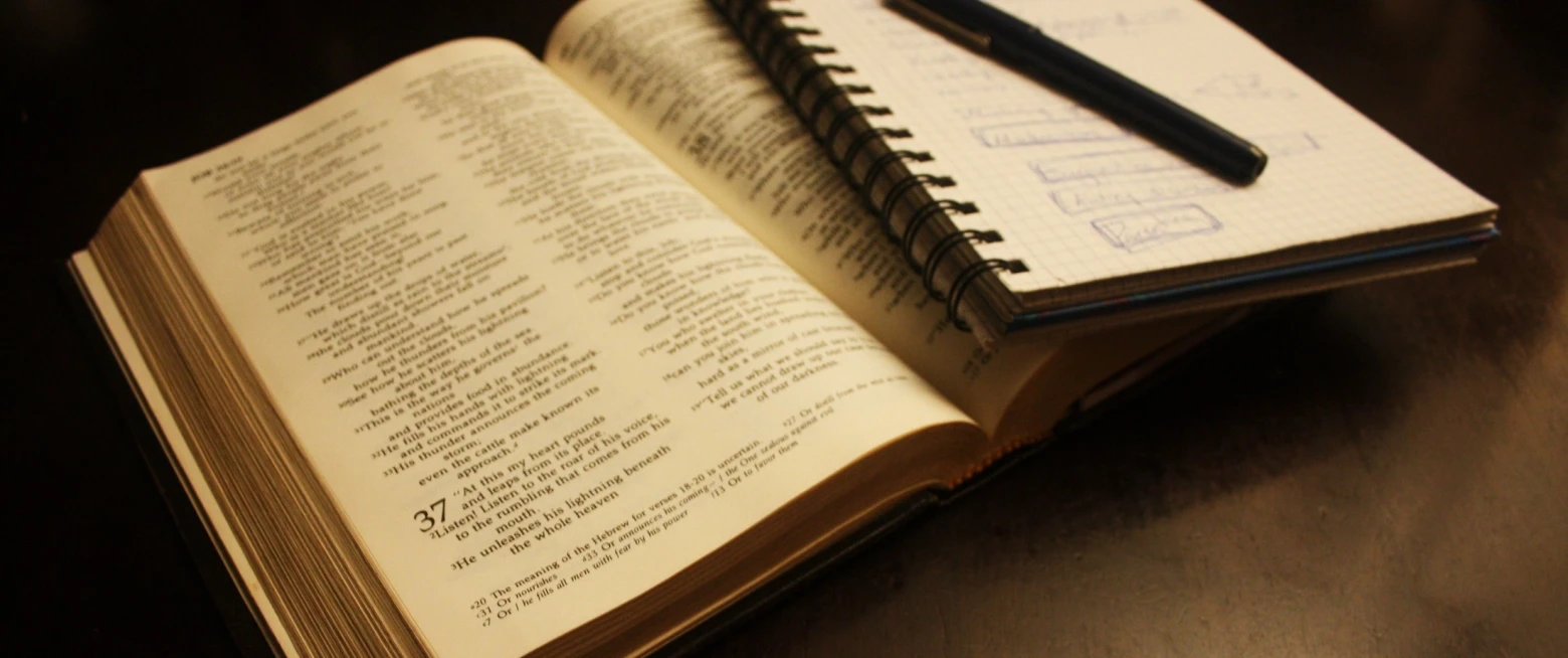 Bible open with notebook
