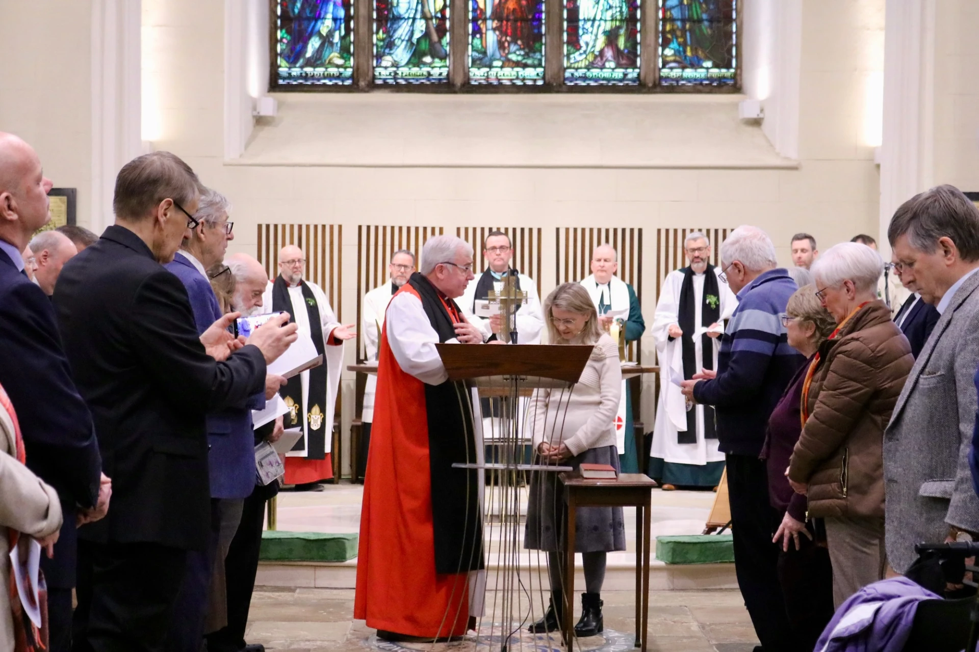 Bishop David prays for Päivi before she speaks