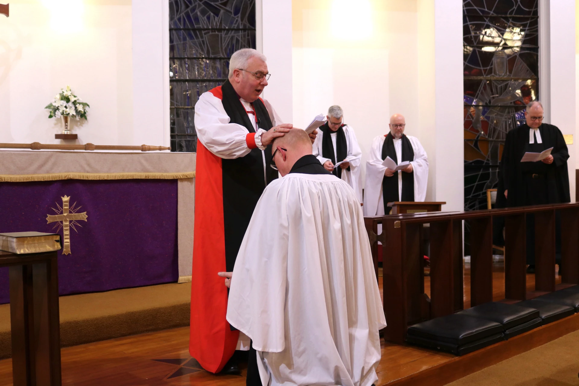 Bishop David prays for the new rector