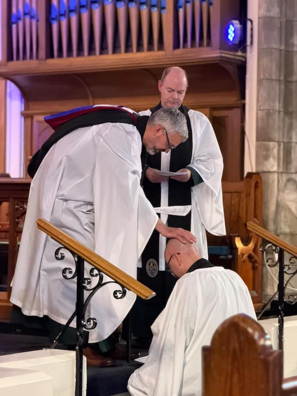 Archdeacon Jim Cheshire prays for Ross