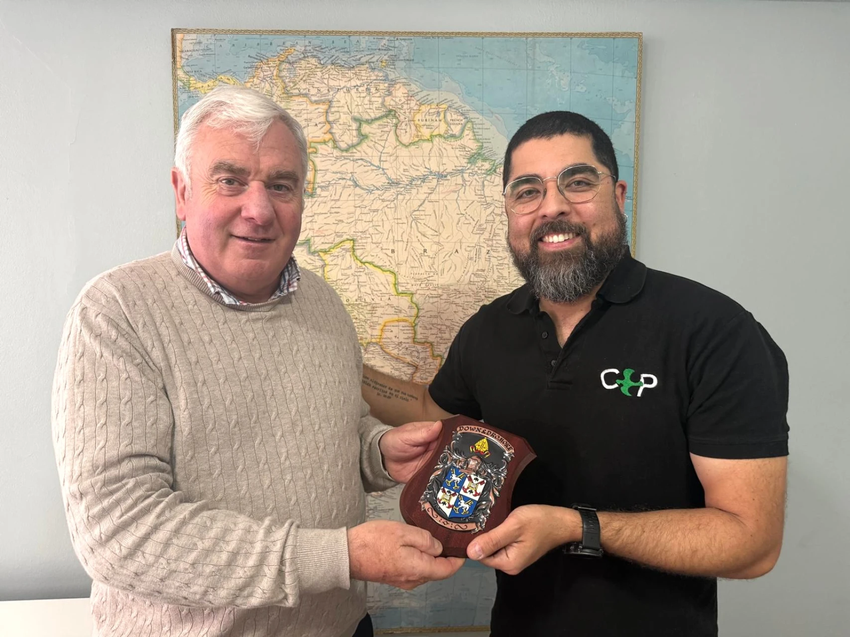 Max receives a Down & Dromore shield from Bishop David