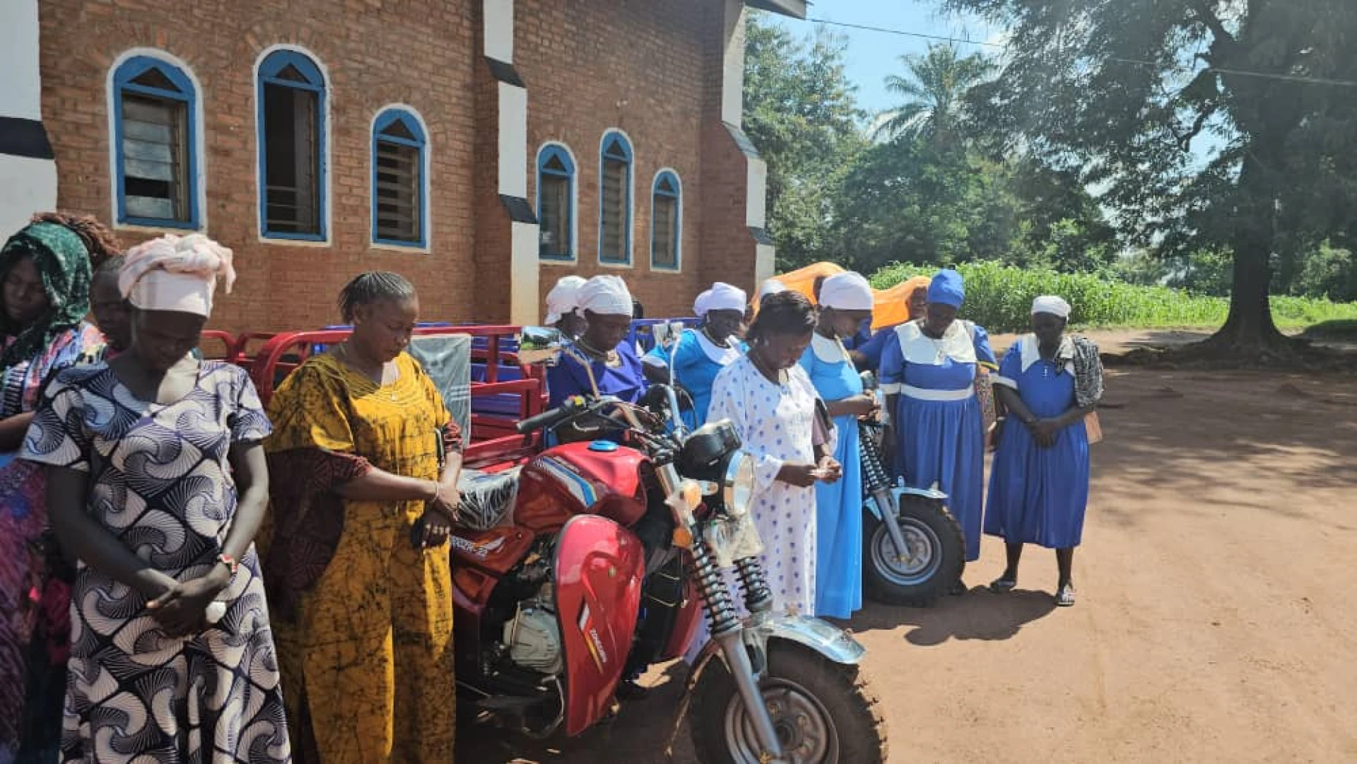 MU ladies, heads bowed in prayer