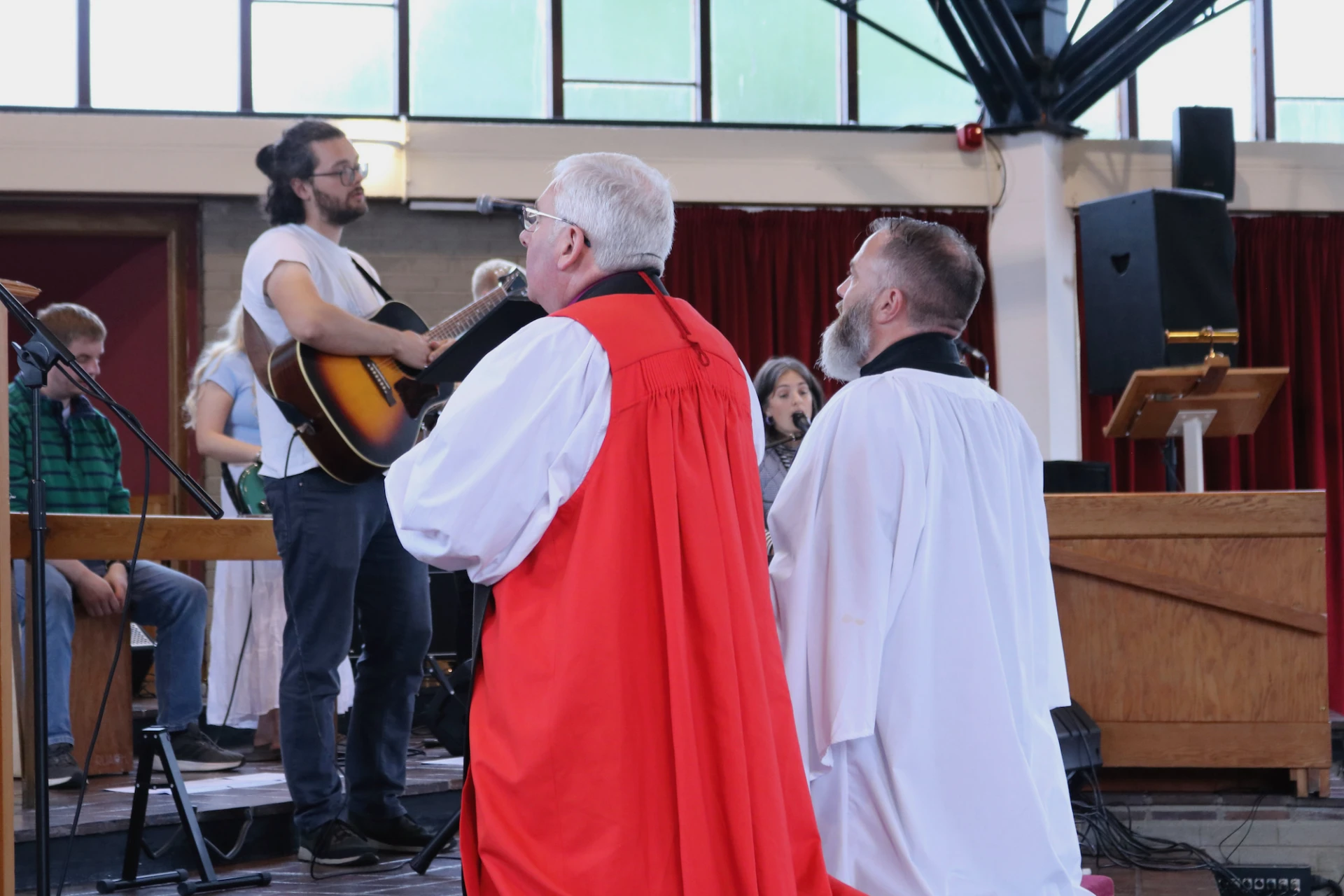 Bishop and Andrew kneel in prayer