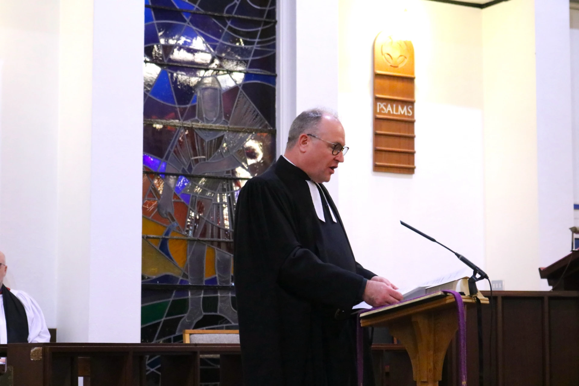 Registrar, Canon Simon Doogan, reads the Bishop's mandate